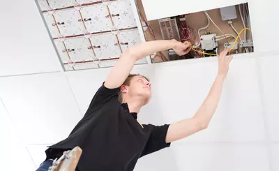 Auszubildender Elektriker arbeitet an Haussteuerung
